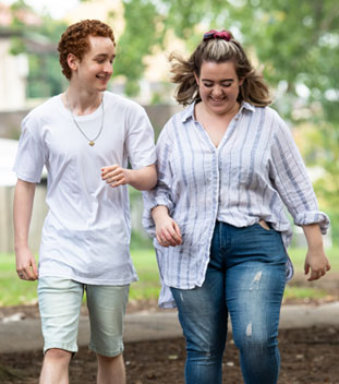 two young people walking and laughing image for youth ambassadors for canteen