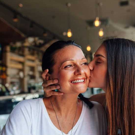 Daughter kisses Mother who has cancer