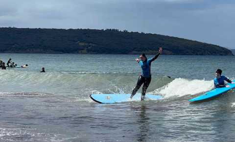 young person trying surfing at dodges ferry