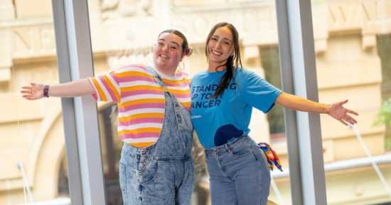 two young girls standing together embracing
