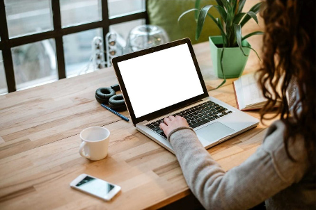 young person using a laptop on a work table