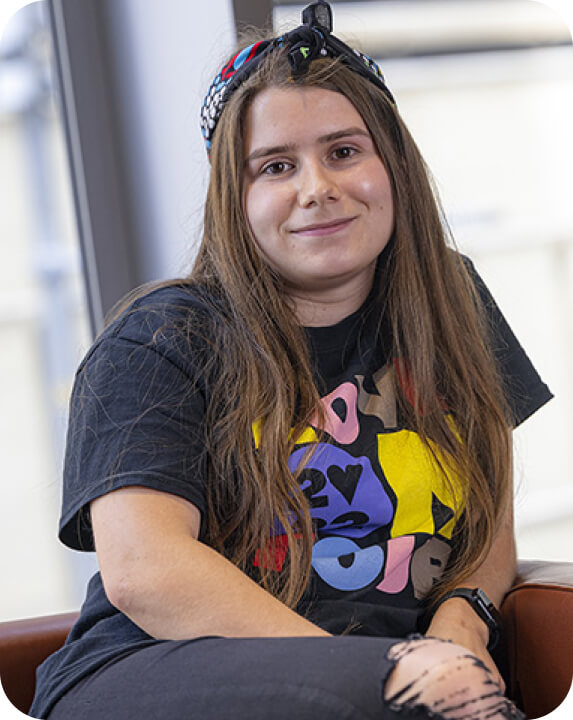 Chloe, a young person who lost her teens entirely to cancer, but is now a proud Canteen youth ambassador, wearing a Canteen bandanna