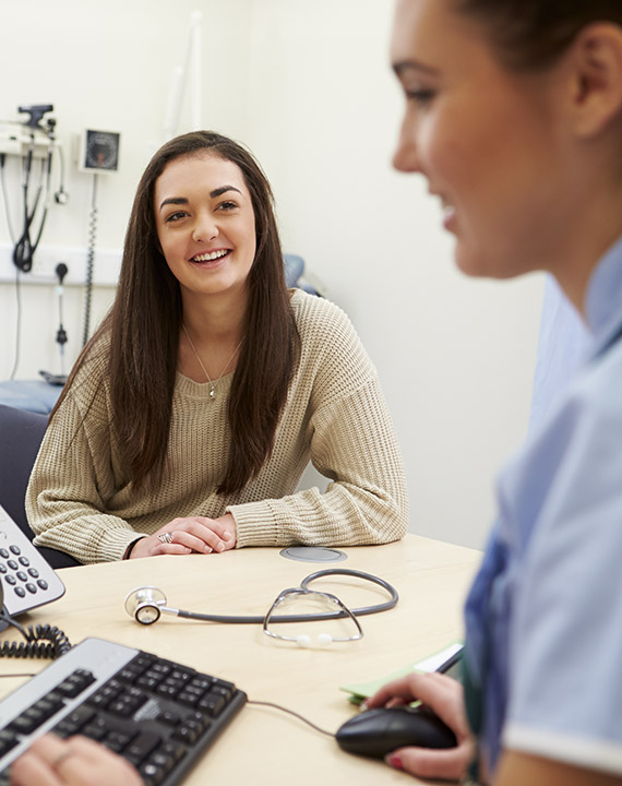 An image of a young cancer patient with a medical professional, demonstrating Canteen's commitment to improving outcomes for adolescent and young adult cancer patients aged 15-25