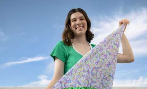 young person holds their bandanna design 