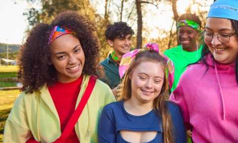 a group of 5 young people wearing bandannas